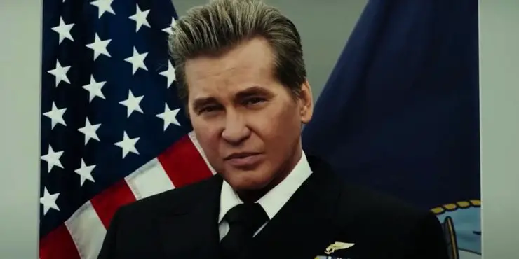Iceman standing in front of the American flag in Top Gun: Maverick
