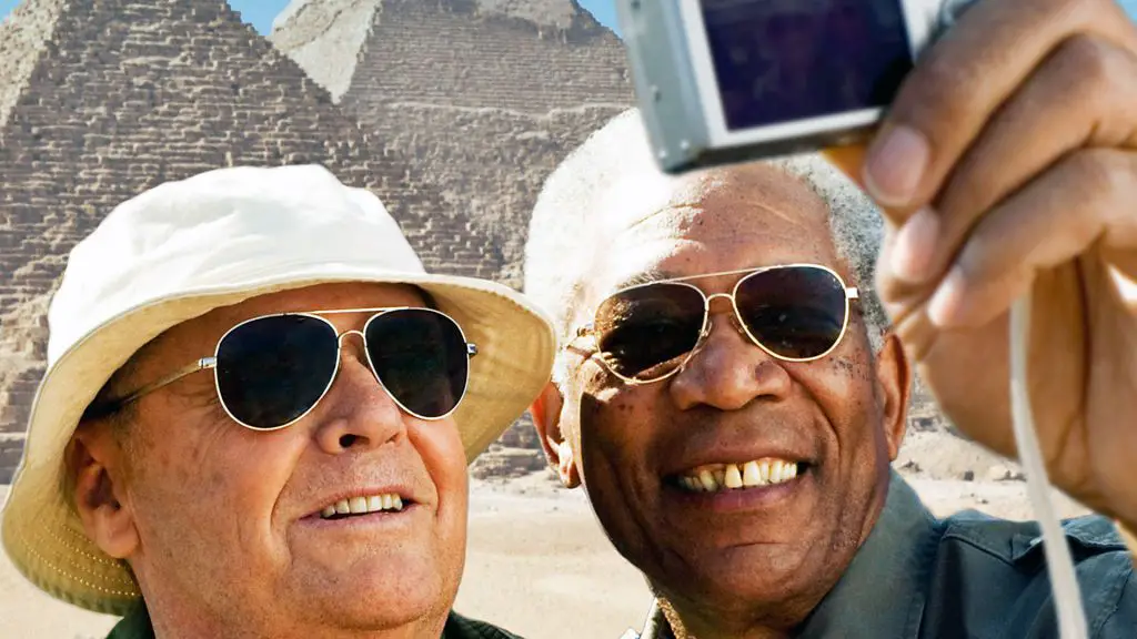 The main characters are photographed against the backdrop of the pyramids in Egypt